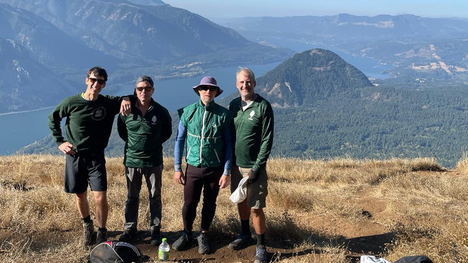 Three alums posing atop Dog Mountain at the Columbia River Gorge, Washington-Oregon border