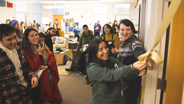 Students cutting the ribbon on a new wellness center on campus
